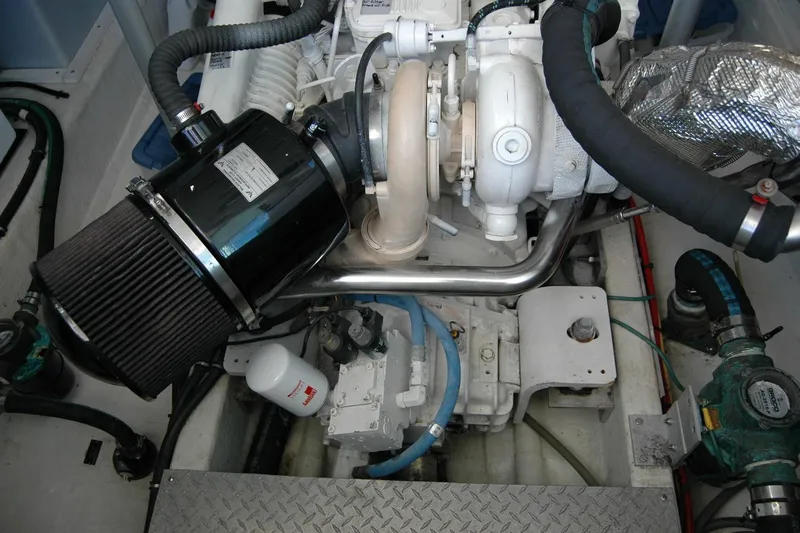 Bonnie Blue Yacht Photos Pics Engine compartment of a 2015 Back Cove 37 boat, showcasing mechanical components and piping.