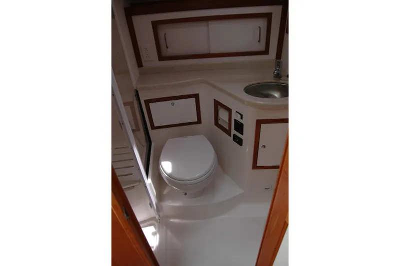 Bonnie Blue Yacht Photos Pics 2015 Back Cove 37 yacht bathroom with toilet, sink, and storage cabinets.