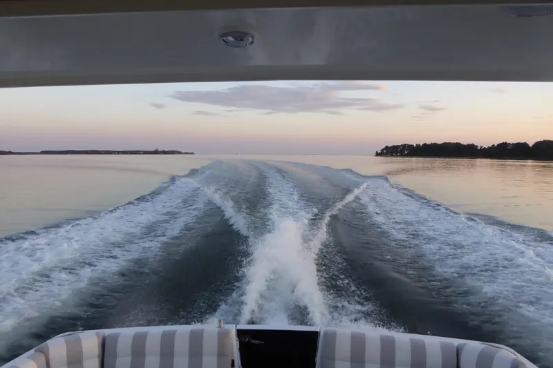 Bonnie Blue Yacht Photos Pics Back Cove 37 boat cruising on calm waters at sunset, 2015 model.