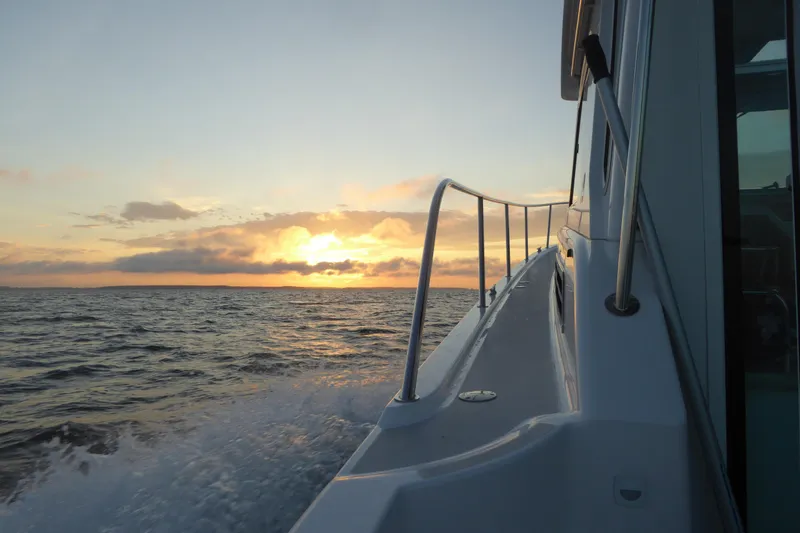 Bonnie Blue Yacht Photos Pics Back Cove 37 boat cruising at sunset, 2015 model, ocean view.