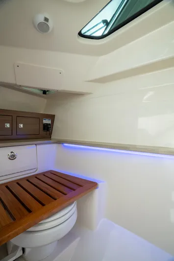 Giorgia I Yacht Photos Pics 2024 Boston Whaler 320 Vantage interior with wooden seat and modern lighting.