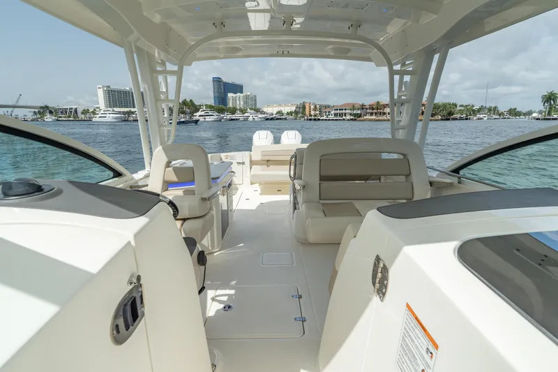 Giorgia I Yacht Photos Pics 2024 Boston Whaler 320 Vantage boat interior with waterfront view, featuring seating and helm.