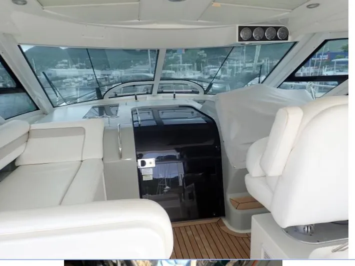 Fiddle Deedee Yacht Photos Pics Interior of 2011 Sea Ray Sundancer yacht with white seating and panoramic windows.