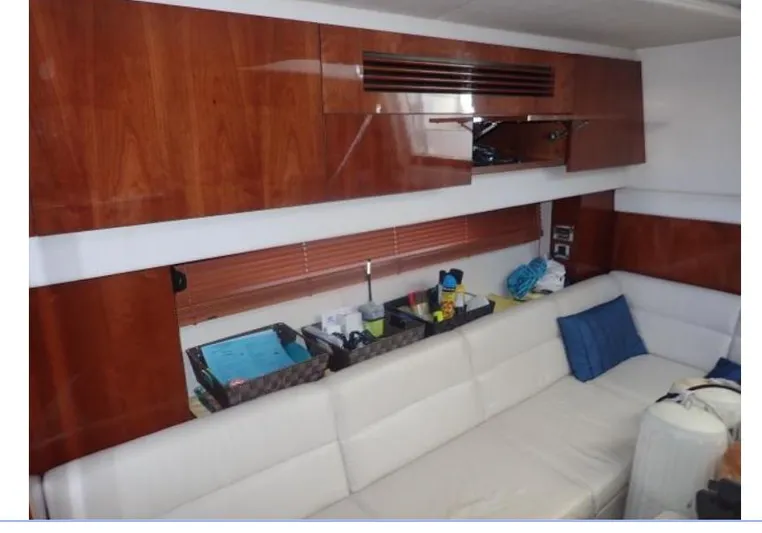 Fiddle Deedee Yacht Photos Pics Interior of 2011 Sea Ray Sundancer yacht with white leather seating and wooden cabinets.