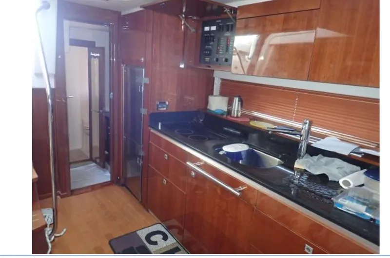 Fiddle Deedee Yacht Photos Pics 2011 Sea Ray Sundancer yacht kitchen with modern appliances and wooden cabinetry.