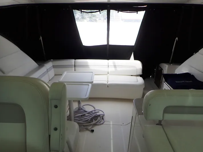 Fiddle Deedee Yacht Photos Pics Interior of 2011 Sea Ray Sundancer yacht with white seating and tables.