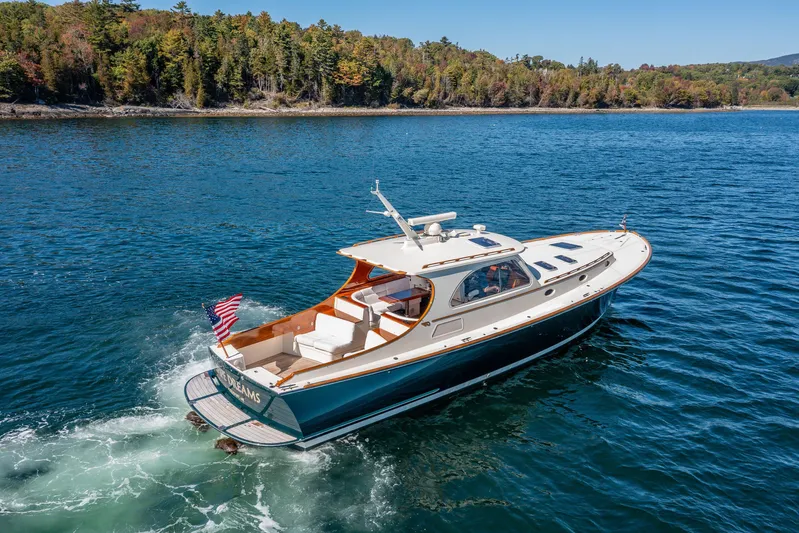 Pipe Dreams Yacht Photos Pics 2002 Hinckley Talaria 44 Express yacht cruising on a scenic lake.