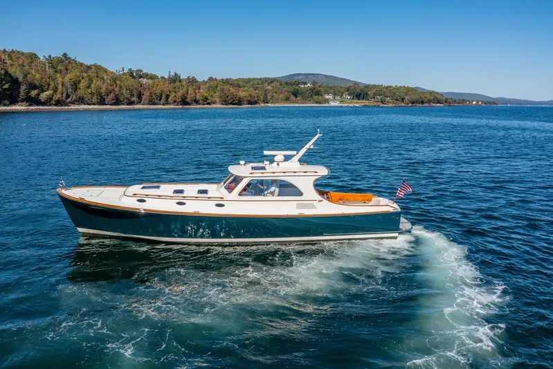 Pipe Dreams Yacht Photos Pics 2002 Hinckley Talaria 44 Express yacht cruising on a scenic lake.