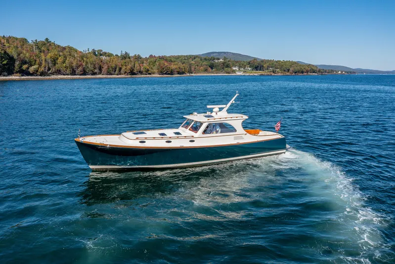 Pipe Dreams Yacht Photos Pics 2002 Hinckley Talaria 44 Express yacht cruising on a scenic lake.