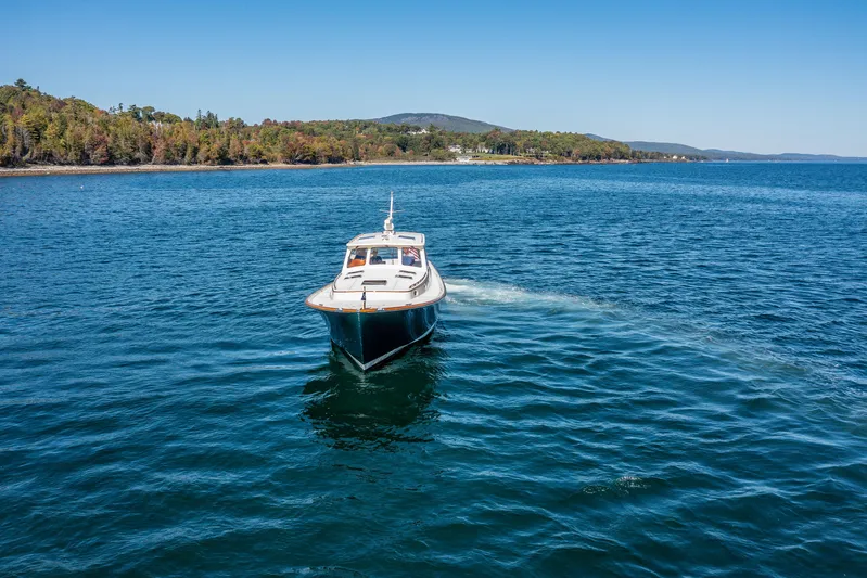 Pipe Dreams Yacht Photos Pics 2002 Hinckley Talaria 44 Express cruising on a scenic lake.