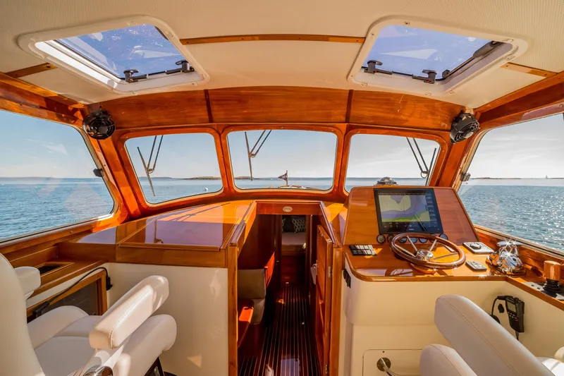 Pipe Dreams Yacht Photos Pics Interior of 2002 Hinckley Talaria 44 Express yacht with wooden dashboard and ocean view.