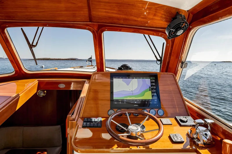 Pipe Dreams Yacht Photos Pics Helm of 2002 Hinckley Talaria 44 Express yacht with navigation display, wooden finish, and ocean view.