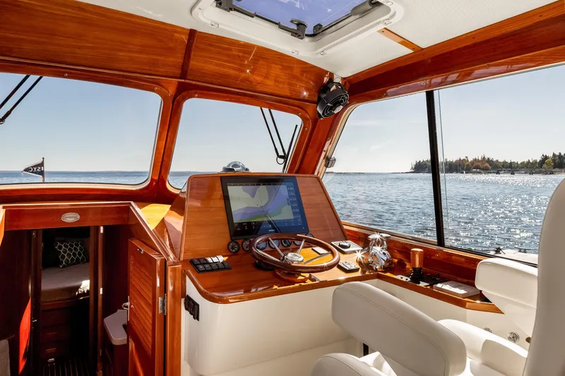Pipe Dreams Yacht Photos Pics Interior view of 2002 Hinckley Talaria 44 Express yacht with wooden dashboard and scenic ocean view.