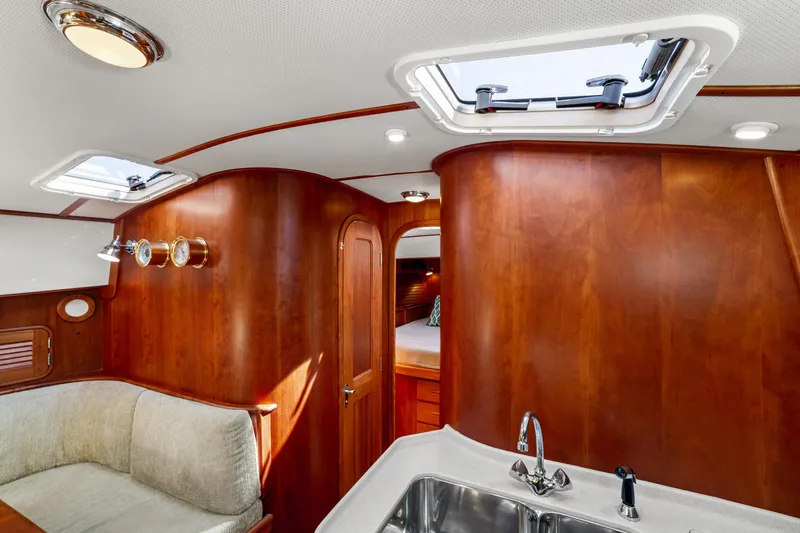 Pipe Dreams Yacht Photos Pics Luxurious 2002 Hinckley Talaria 44 Express yacht interior with wood finish and skylight.