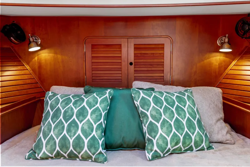 Pipe Dreams Yacht Photos Pics Cozy cabin interior of 2002 Hinckley Talaria 44 Express with green decorative pillows.