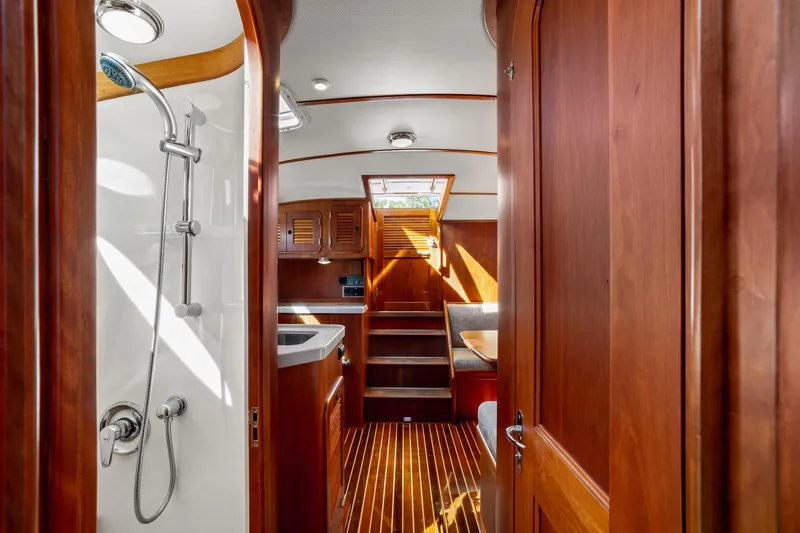 Pipe Dreams Yacht Photos Pics Luxurious 2002 Hinckley Talaria 44 Express yacht interior with wooden finish and shower.