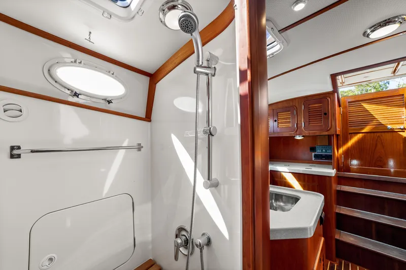 Pipe Dreams Yacht Photos Pics Luxurious 2002 Hinckley Talaria 44 Express yacht bathroom with wood accents and modern fixtures.