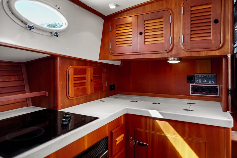 Pipe Dreams Yacht Photos Pics Hinckley Talaria 44 Express 2002 yacht interior with wooden cabinetry and modern kitchen amenities.