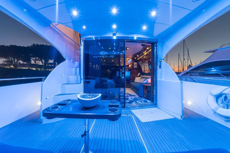 Believe Yacht Photos Pics Luxurious 2004 Marquis Motor Yacht interior with ambient blue lighting at sunset.