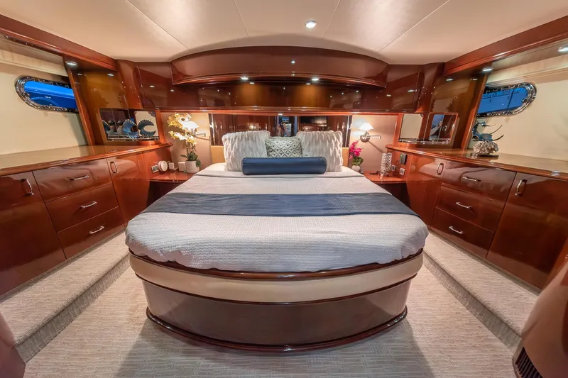 Believe Yacht Photos Pics Luxurious 2004 Marquis Motor Yacht bedroom with elegant wood finishes and cozy bedding.