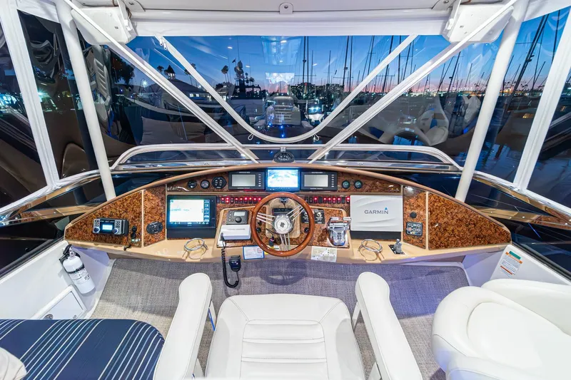 Believe Yacht Photos Pics Luxurious 2004 Marquis Motor Yacht helm with advanced navigation systems and elegant wood finish.