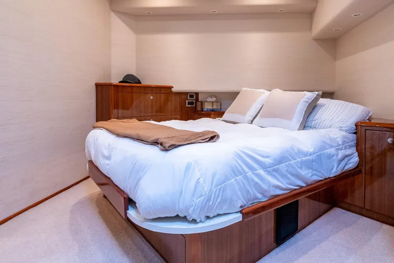 "five Seas" Yacht Photos Pics Luxurious bedroom interior of 2007 Viking 64 Convertible yacht with elegant wood finish.