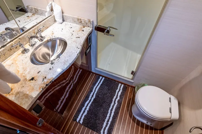 "five Seas" Yacht Photos Pics Luxurious bathroom in 2007 Viking 64 Convertible yacht with marble countertop and modern fixtures.