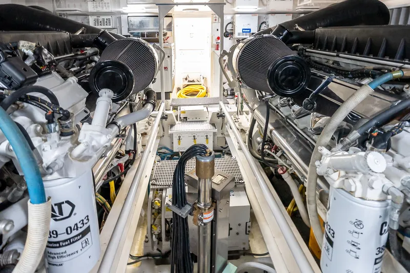 "five Seas" Yacht Photos Pics Engine room of a 2007 Viking 64 Convertible yacht, showcasing dual engines and equipment.