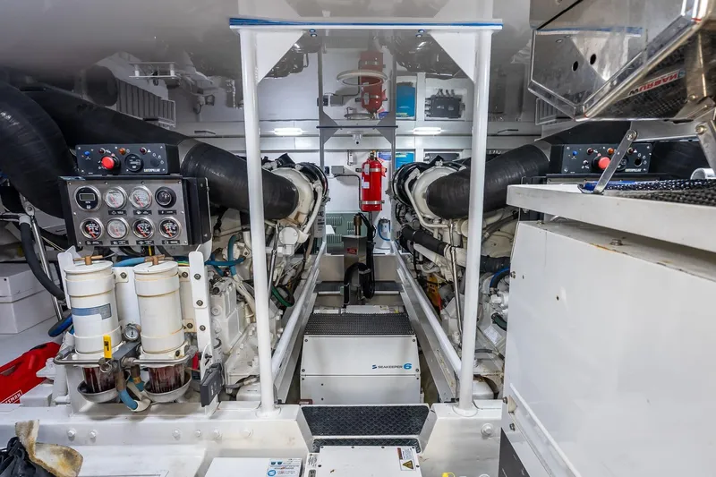 "five Seas" Yacht Photos Pics Engine room of a 2007 Viking 64 Convertible yacht, featuring dual engines and control panels.