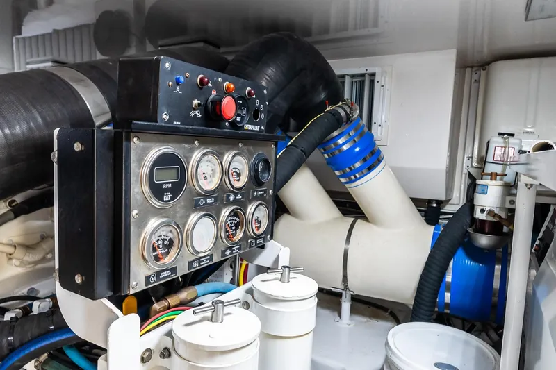 "five Seas" Yacht Photos Pics Engine room of 2007 Viking 64 Convertible yacht with control panel and gauges.