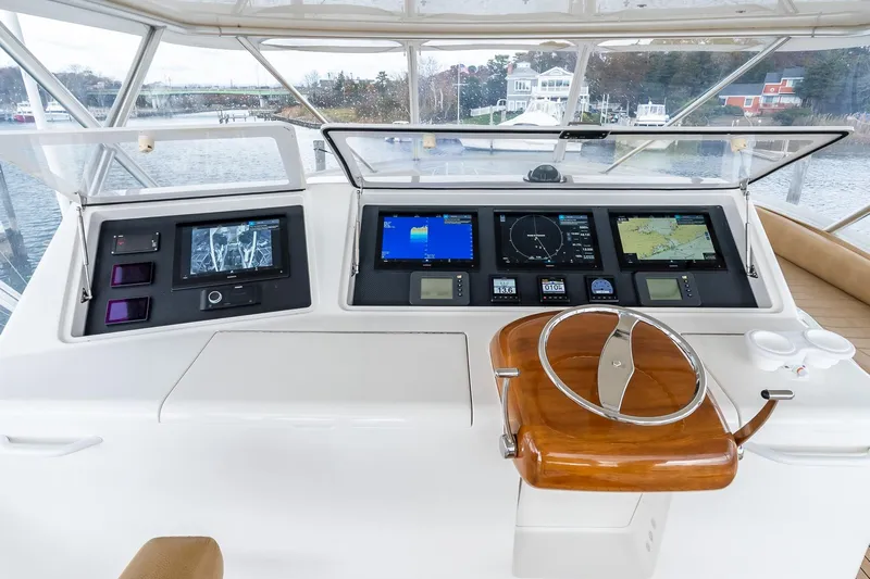 "five Seas" Yacht Photos Pics 2007 Viking 64 Convertible yacht helm with advanced navigation displays and wooden steering wheel.