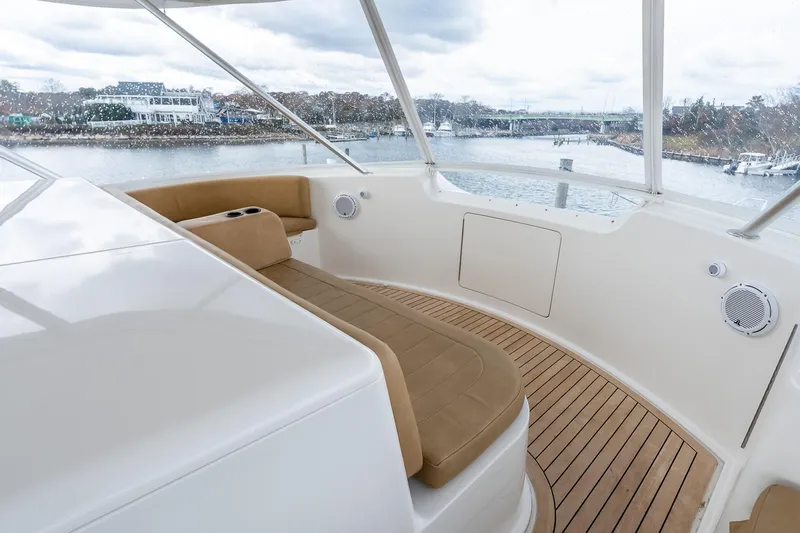 "five Seas" Yacht Photos Pics 2007 Viking 64 Convertible yacht interior with tan seating and wooden deck.