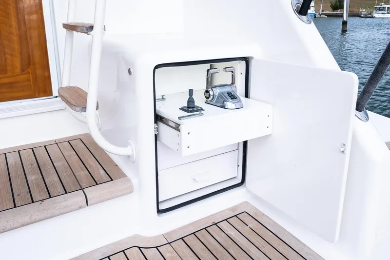 "five Seas" Yacht Photos Pics 2007 Viking 64 Convertible yacht control panel with open storage compartment.