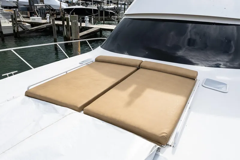 "five Seas" Yacht Photos Pics 2007 Viking 64 Convertible yacht with tan sun pads on deck, docked at marina.