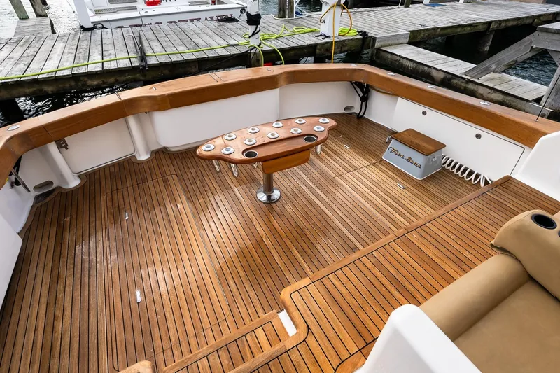 "five Seas" Yacht Photos Pics 2007 Viking 64 Convertible yacht deck with teak flooring and fishing rod holders.