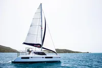 2019 Leopard 45 catamaran sailing on clear blue waters.