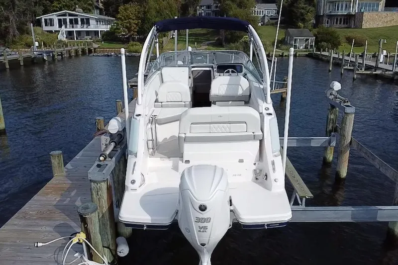  Yacht Photos Pics 2024 Regal 26 XO boat docked at a marina, featuring a powerful outboard motor.