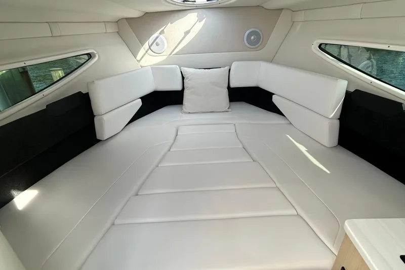  Yacht Photos Pics 2024 Regal 26 XO cabin interior with white leather seating and modern design.