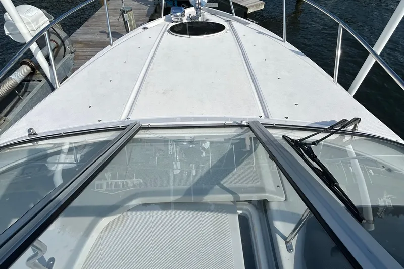  Yacht Photos Pics 2024 Regal 26 XO boat deck view at dock, showcasing windshield and railing.