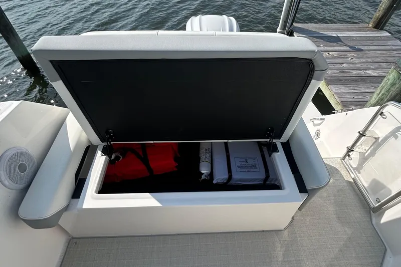  Yacht Photos Pics 2024 Regal 26 XO boat storage compartment with safety equipment and life jackets.