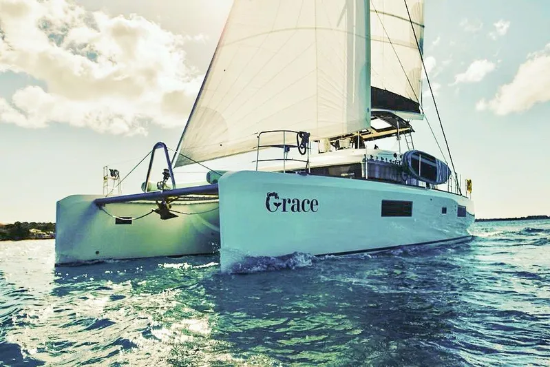 Grace Yacht Photos Pics 2020 Lagoon 52 F catamaran sailing on open water under clear skies.