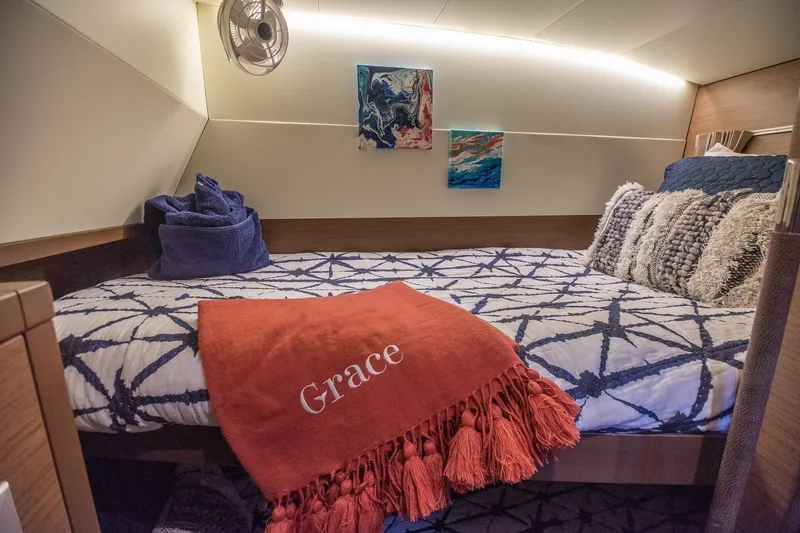 Grace Yacht Photos Pics Cozy cabin interior of 2020 Lagoon 52 F yacht with decorative pillows and artwork.