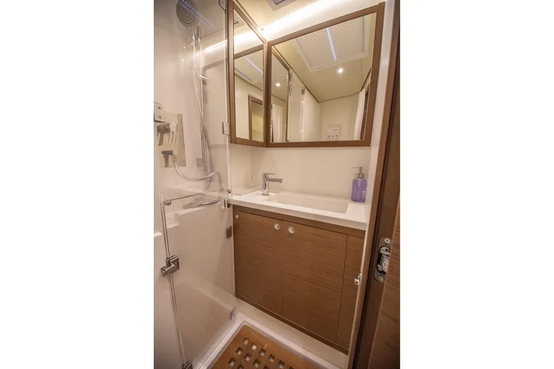 Grace Yacht Photos Pics Modern bathroom in 2020 Lagoon 52 F yacht with shower and wooden cabinetry.