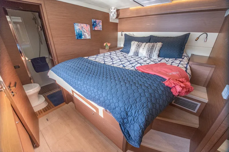 Grace Yacht Photos Pics Luxurious bedroom interior of 2020 Lagoon 52 F yacht with modern decor and ensuite bathroom.