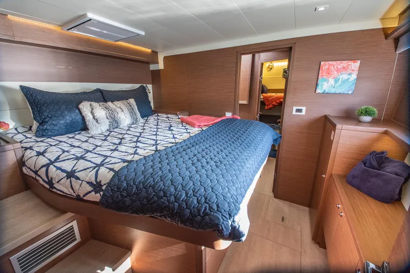 Grace Yacht Photos Pics Luxurious cabin interior of 2020 Lagoon 52 F yacht with cozy bedding and modern decor.