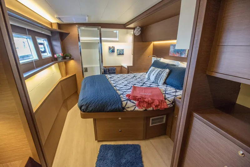 Grace Yacht Photos Pics Luxurious cabin interior of 2020 Lagoon 52 F yacht with cozy bed and modern decor.