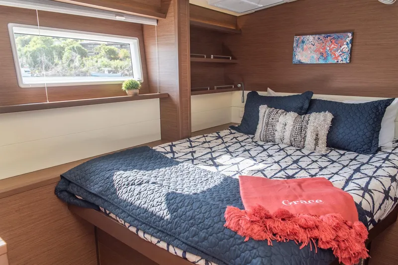 Grace Yacht Photos Pics Luxurious cabin interior of 2020 Lagoon 52 F yacht with cozy bedding and decor.