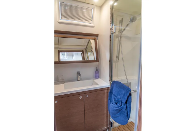 Grace Yacht Photos Pics Modern bathroom in 2020 Lagoon 52 F yacht with shower and wooden cabinetry.