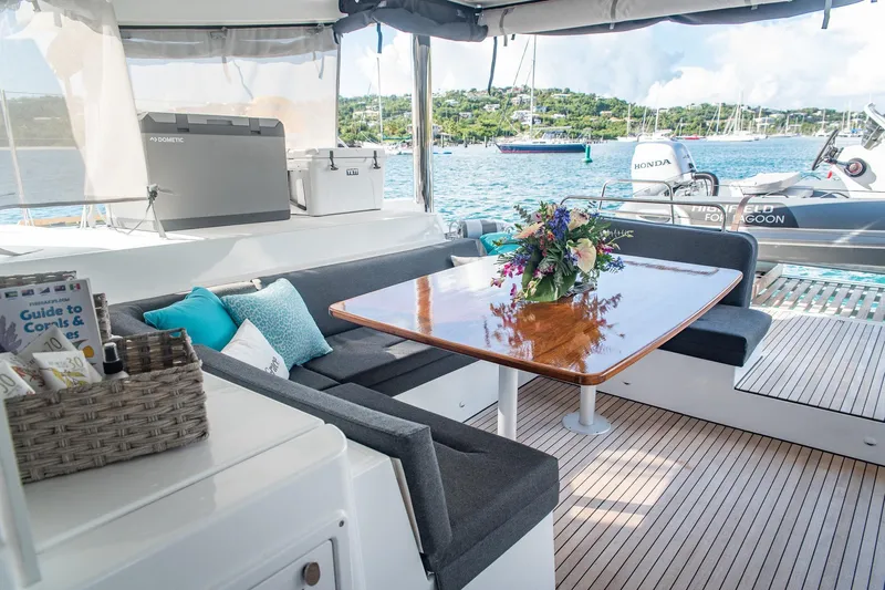 Grace Yacht Photos Pics Luxurious Lagoon 52 F yacht interior with elegant seating and floral centerpiece, 2020 model.