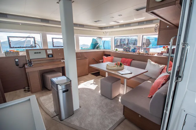 Grace Yacht Photos Pics Luxurious interior of 2020 Lagoon 52 F catamaran with modern seating and panoramic windows.